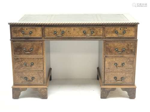 Late 20th century elm twin pedestal desk, rectangular moulded top with green leather inset, fitted w