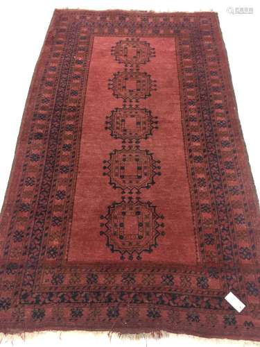 Afghan red ground rug, field decorated with Guls, repeating border, 204cm x 112cm