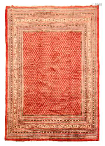 Araak red ground rug, field decorated with repeating Boteh motifs, graduated multicoloured striped g