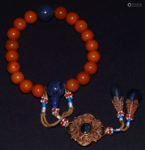 AN AMBER CARVED BRACELET