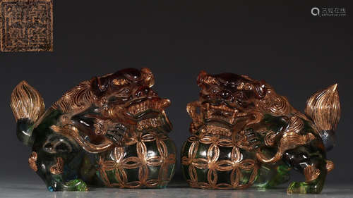 PAIR OF GLASS CARVED LION SHAPE PENDANTS