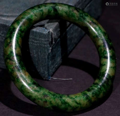 A JADEITE CARVED BANGLE