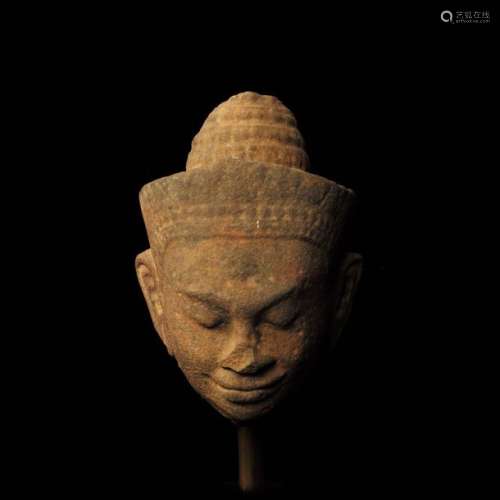 Vishnu's head wearing a conical tiara set with an …