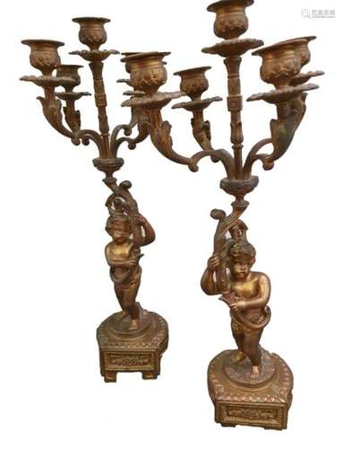 1 pair of bronze candlesticks representing Puttis …