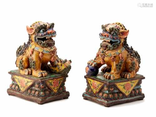 A PAIR OF VIVIDLY GLAZED POTTERY FOO DOGS (2)