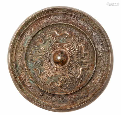 A SILVERY BRONZE CIRCULAR MIRROR