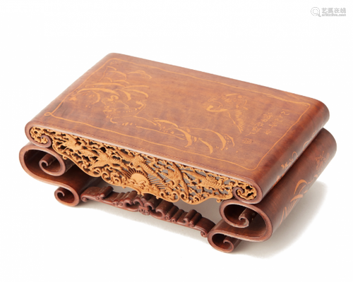 AN INTRICATELY CARVED RECTANGULAR WOOD STAND