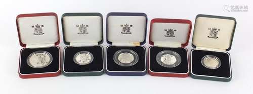 Five silver proof coins with cases comprising two fifty pence pieces, two two pound coins and a