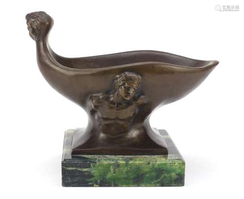 Classical patinated bronze centrepiece decorated with figures, raised on a green marbleised base,