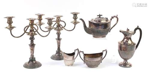 Silver plated items including a three piece teaset and pair of two branch candelabras, the largest