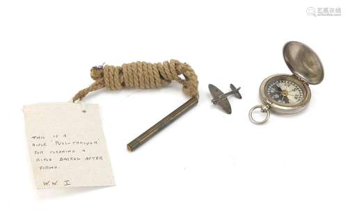 Military interest items including a Spitfire brooch and World War I compass by J Hicks London,