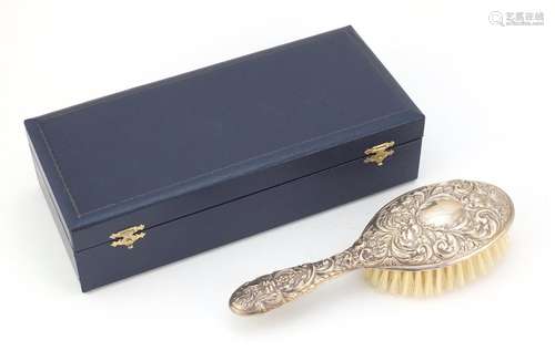 Silver backed clothes brush by WI Broadway & Co, embossed with face masks, birds and foliage,