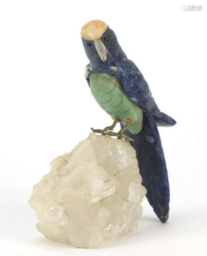 Chinese lapis lazuli, jade and hardstone parrot perched on a naturalistic rock crystal base, 14cm