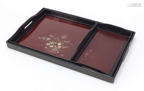 Japanese lacquered three tray set with gold flecking, each decorated with flowers and with twin