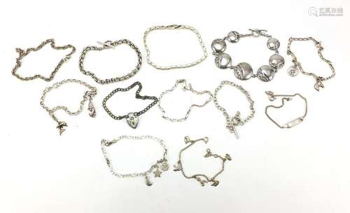 Twelve silver bracelets including charm bracelets, 89.0g : For Further Condition Reports Please