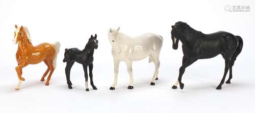 Three collectable horses and a foal comprising two Royal Doulton and two Beswick, the largest 25cm