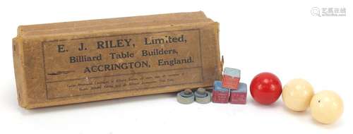 Three turned ivory billiard balls, one stained red, housed in E J Riley box, each 4.5cm in