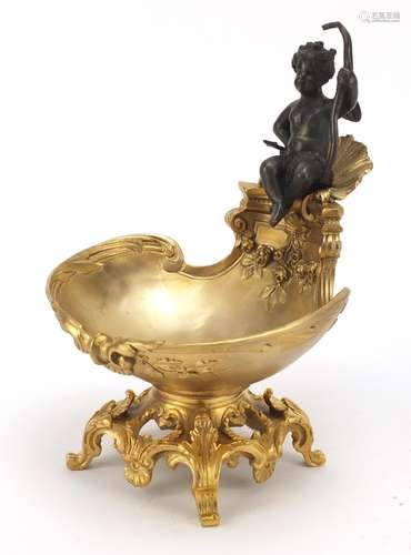 Partially gilt bronze sweetmeat dish in the form of Putti seated on a shell above a bowl,