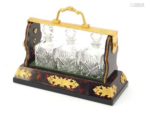 Gilt metal and boulle style tantalus with three cut glass decanters, 26.5cm wide : For Further