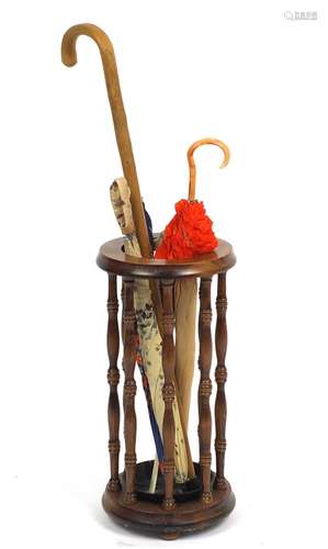 Mahogany stick stand with a selection of walking sticks and umbrellas : For Further Condition