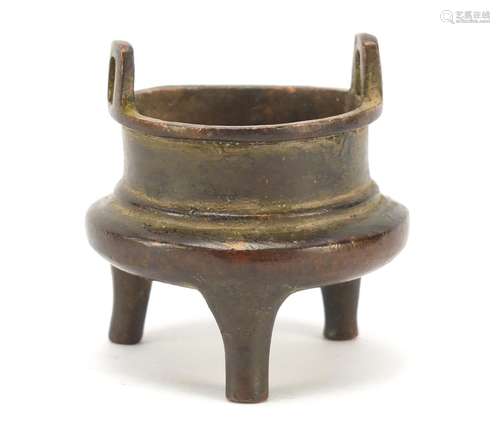 Miniature Chinese patinated bronze tripod incense burner, character marks to the base, 5.5cm