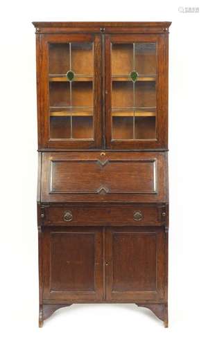 Arts & Crafts oak bureau bookcase fitted with a pair of leaded glass doors above a fall, freize