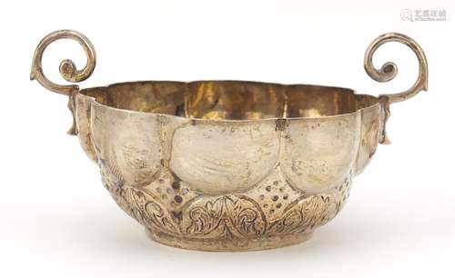 Continental silver circular bowl with twin handles and embossed with flowers, indistinct impressed