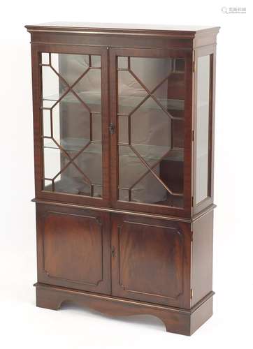 Mahogany display cabinet fitted with a pair of glazed doors enclosing two glass shelves above a pair