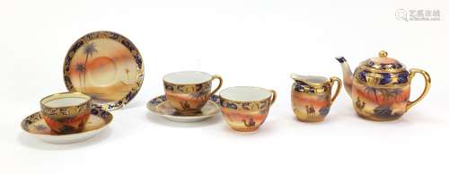 Noritake teaware hand painted with desert scenes including teapot and two cups with saucers, the