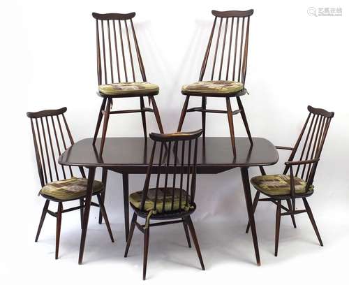 Ercol elm extending dining table with five stick back chairs and leaf, the table 71cm H x 152cm W