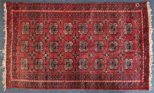 Rectangular Persian rug having an all over floral design onto a red ground, 169cm x 99cm : For