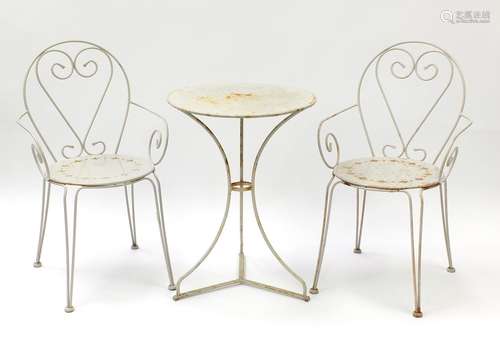 Wrought iron garden table and two chairs, the table 72cm high x 53cm in diameter : For Further