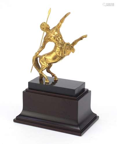 Classical gilt metal sculpture of a centaur, raised on a rectangular black marble and mahogany base,