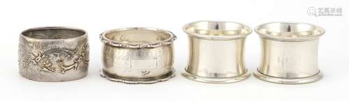 Four Victorian and later circular silver napkin rings, various hallmarks, the largest 5cm in