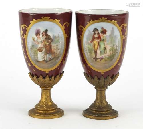 Pair of Vienna style porcelain vases with gilt metal pedestal bases, each decorated with a panel