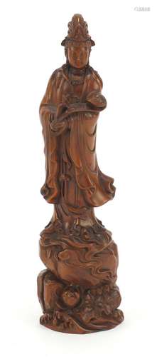 Chinese hardwood carving of Guanyin holding a sceptre standing on a rock, 21cm high : For Further