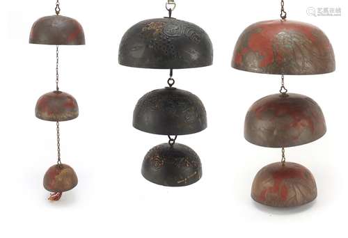 Three graduated Chinese temple bells, including two hand painted and engraved with flowers, the