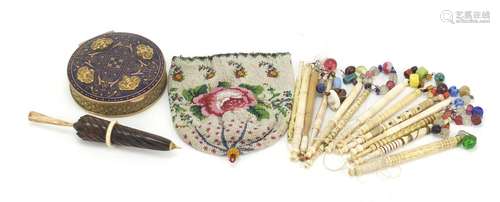 Antique and later objects comprising an 18th century beadwork cover, bone bobbins, treen needle case