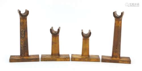 Four antique wooden stands, each with impressed numbers, the largest 22.5cm high : For Further