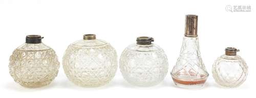 Five cut glass scent bottles, four with silver collars, the largest 14.5cm high : For Further