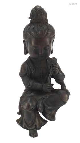 Chinese patinated bronze figure of a seated girl holding a flower, character marks to the reverse,