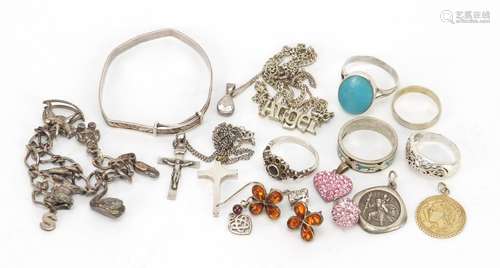 Silver and white metal jewellery including a pair of natural amber earrings, rings and pendants,