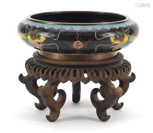 Chinese cloisonné squatted bowl raised on carved hardwood stand, enamelled with dragons chasing a