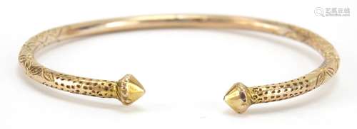 Unmarked gold bangle, (tests as 9ct gold) engraved with flowers, 7cm wide, 21.8g : For Further