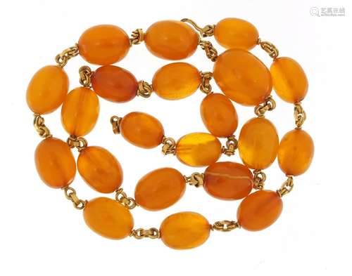 Butterscotch amber coloured bead and unmarked gold necklace, (tests as 18ct gold) 50cm in length,