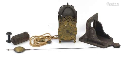 18th/19th century brass lantern clock with oak bracket, the floral chased dial having a chapter ring