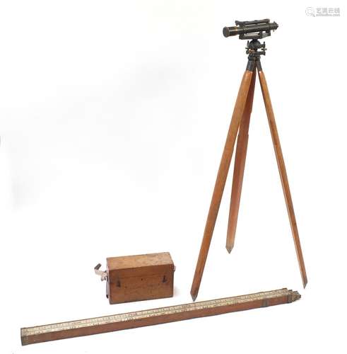 Surveyor's instruments comprising a Stanley theodolite on stand and a measuring stick by Holborn