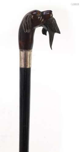 Ebonised walking stick with silver collar and pommel carved in the form of a dog with it's catch,