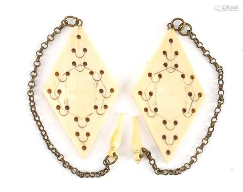 Pair of Victorian diamond shaped ivory game markers, each engraved with arrows and stamped patent,