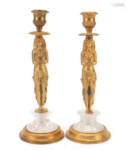 Pair of French Empire style Egyptian revival gilt bronze and rock crystal candlesticks, each 25cm